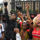 John Boyega raises a fist of solidarity alongside protesters outside Parliament Square in London, England.